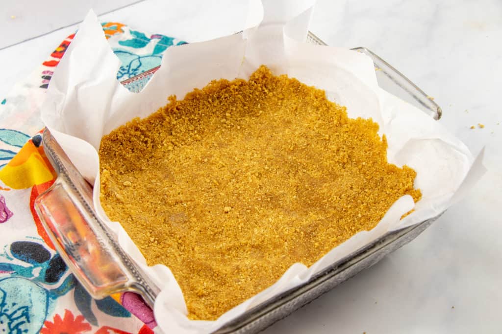 crushed graham crackers pressed into a square baking pan