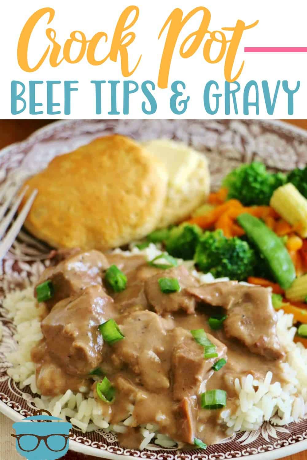 Easy Crock Pot Beef Tips and Gravy shown served over rice with vegetables and a biscuit on a plate. 