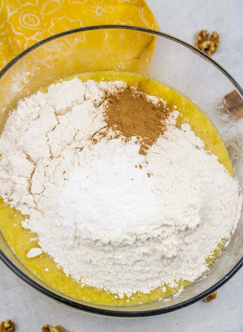 adding dry ingredients, all-purpose flour, baking soda and ground cinnamon in a bowl.