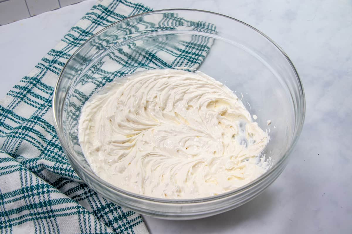 sour cream and cream cheese mixed together in a bowl.