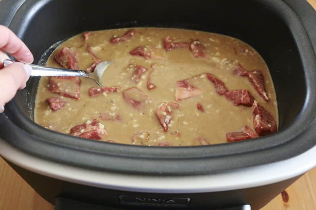 seasoned chuck roast added to gravy mix in a 6-quart slow cooker.