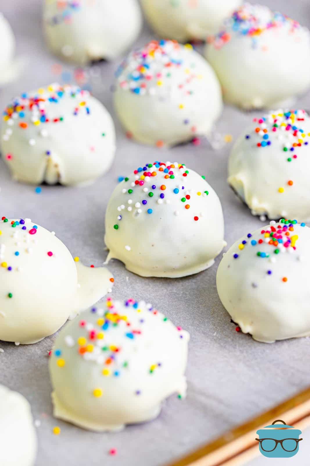 fully coated cookie balls on a baking tray.