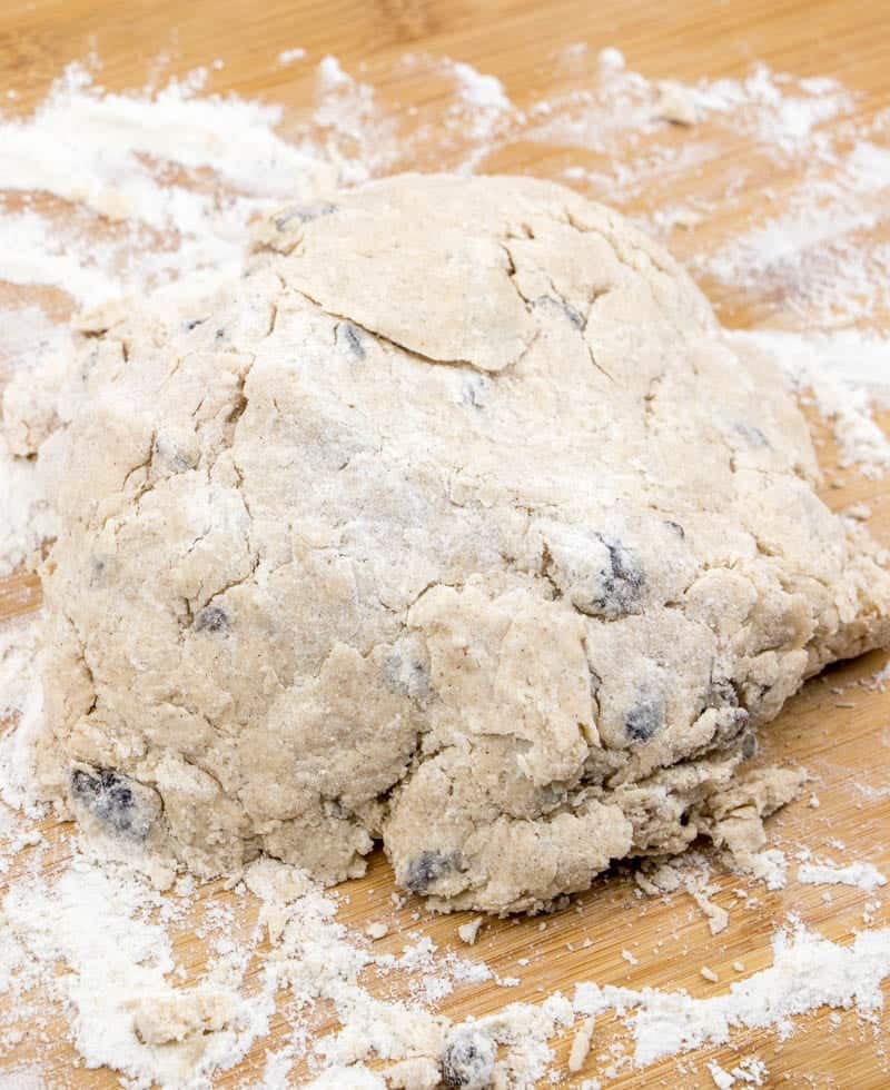cinnamon raisin biscuit dough on counter topped with flour.