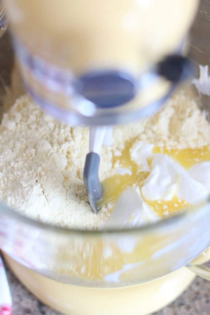 cake mix, eggs, sour cream, and oil mixed in a KitchenAid stand mixer