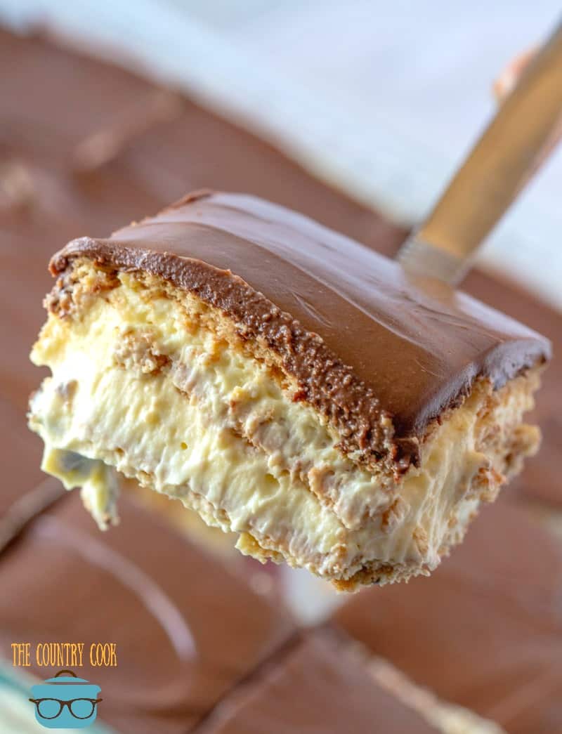 a spatula holding up a slice of eclair cake.