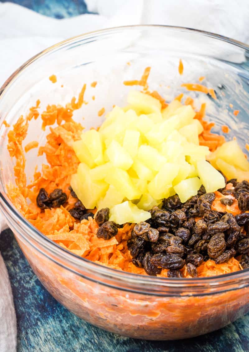 pineapple tidbits, raisins and shredded carrots in a bowl