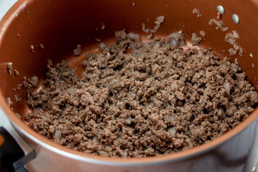 browning ground beef in a sauce pan
