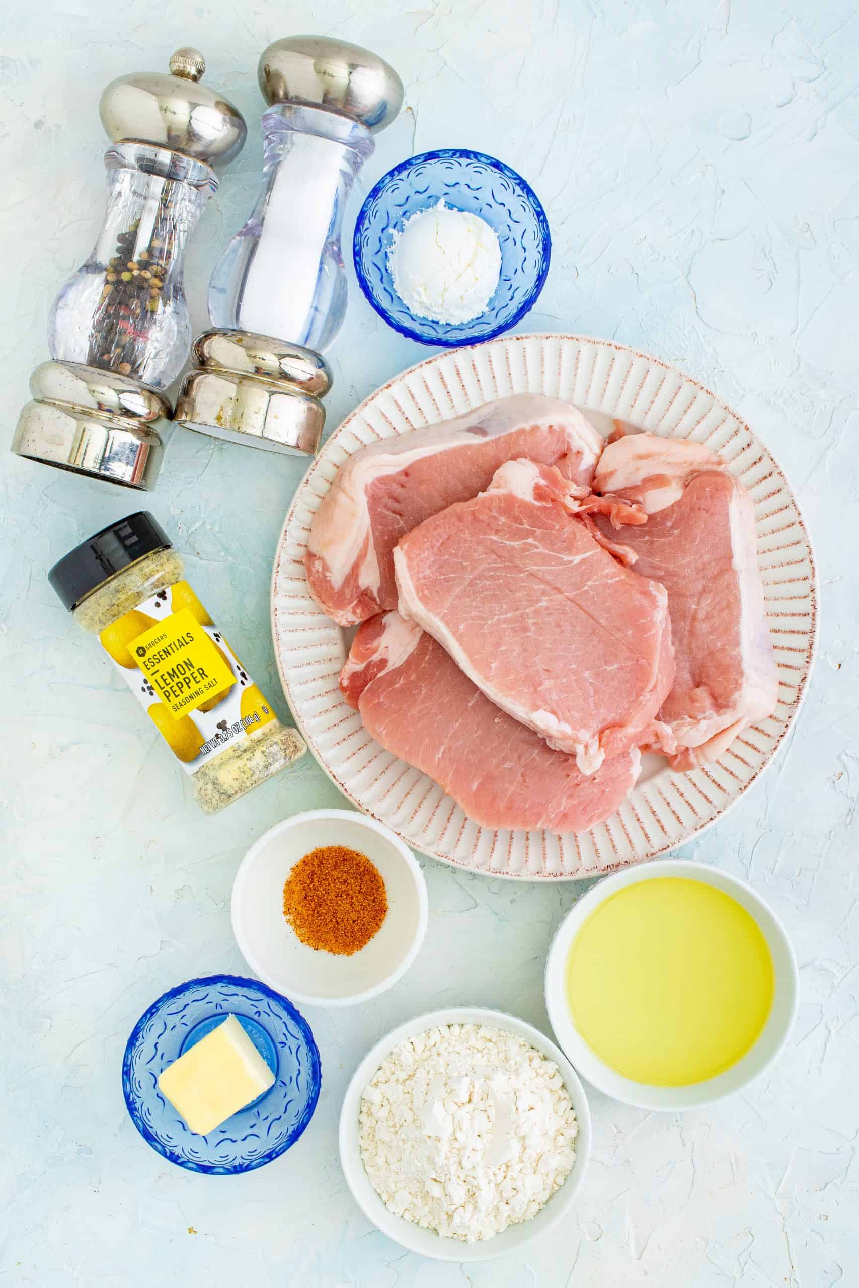 Ingredients for Pan Fried Pork Chops: boneless pork chops, vegetable oil, salted butter, all-purpose flour, corn starch, lemon pepper seasoning, cajun seasoning, salt and pepper