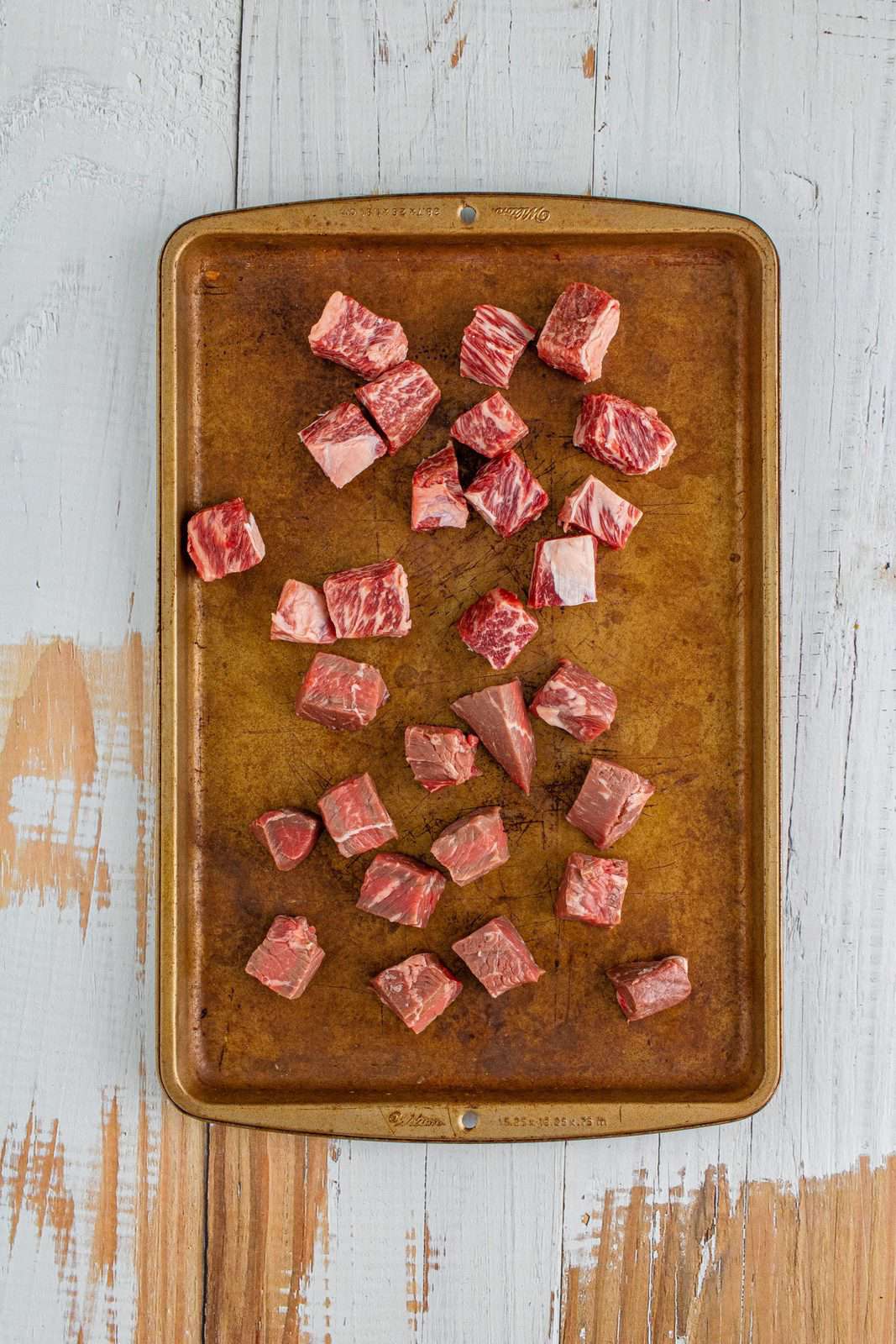 meat cubes shown on a cookie sheet