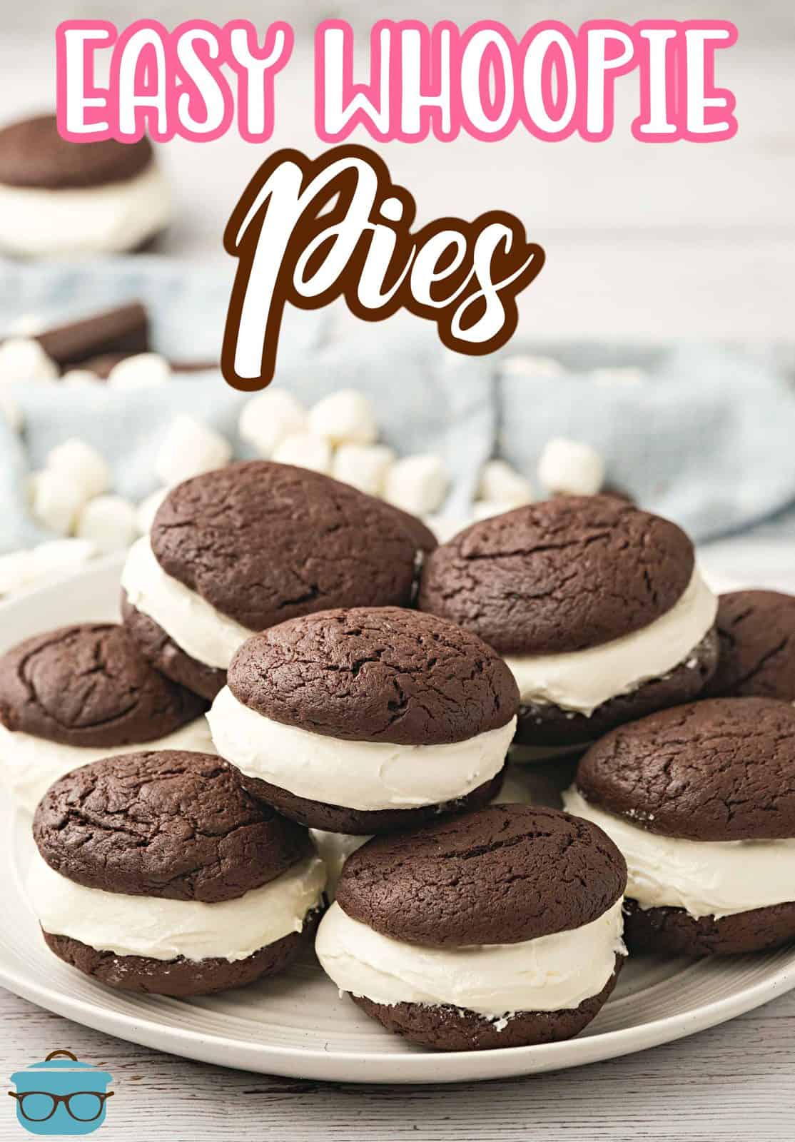 A stack of chocolate whoopie pies shown on a round white plate. 