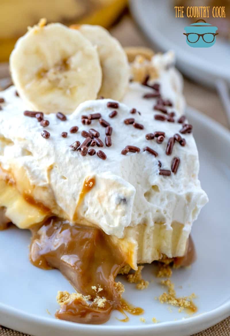 Easy No-Bake Banana Toffee Pie, slice on a plate with a small bite removed.