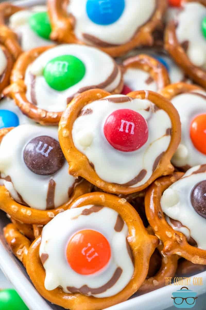 closeup photo of pretzel, Hershey's Kiss and M&M chocolate candy treats