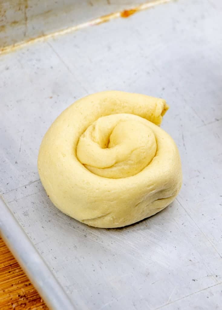 rolled up crescent roll dough in a spiral shape.