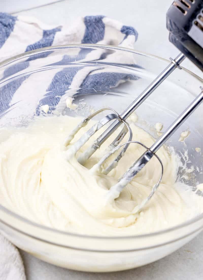 cheesecake cream cheese filling batter in a clear bowl.
