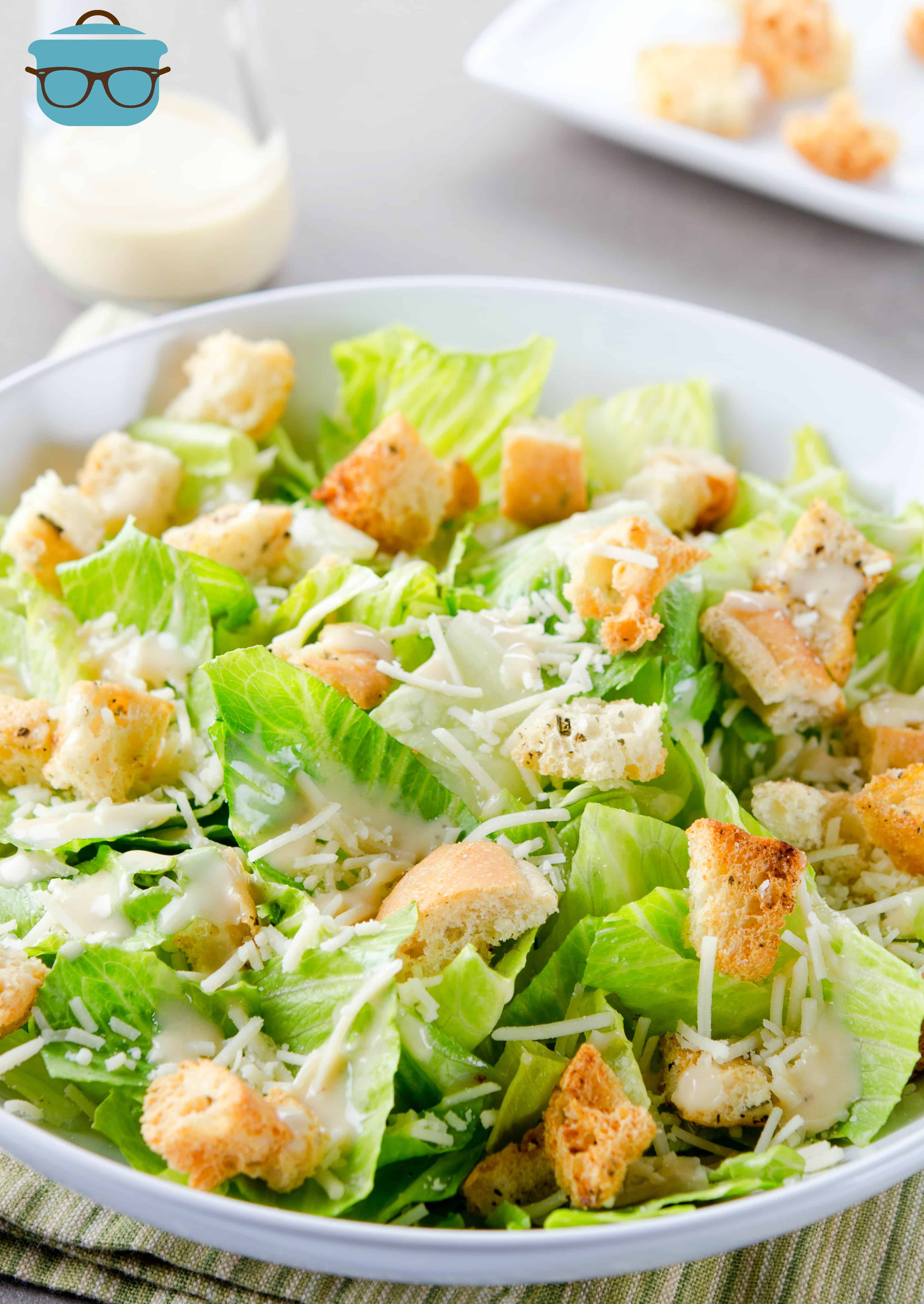 finished Caesar salad with Parmesan Cheese and homemade Caesar salad dressing.