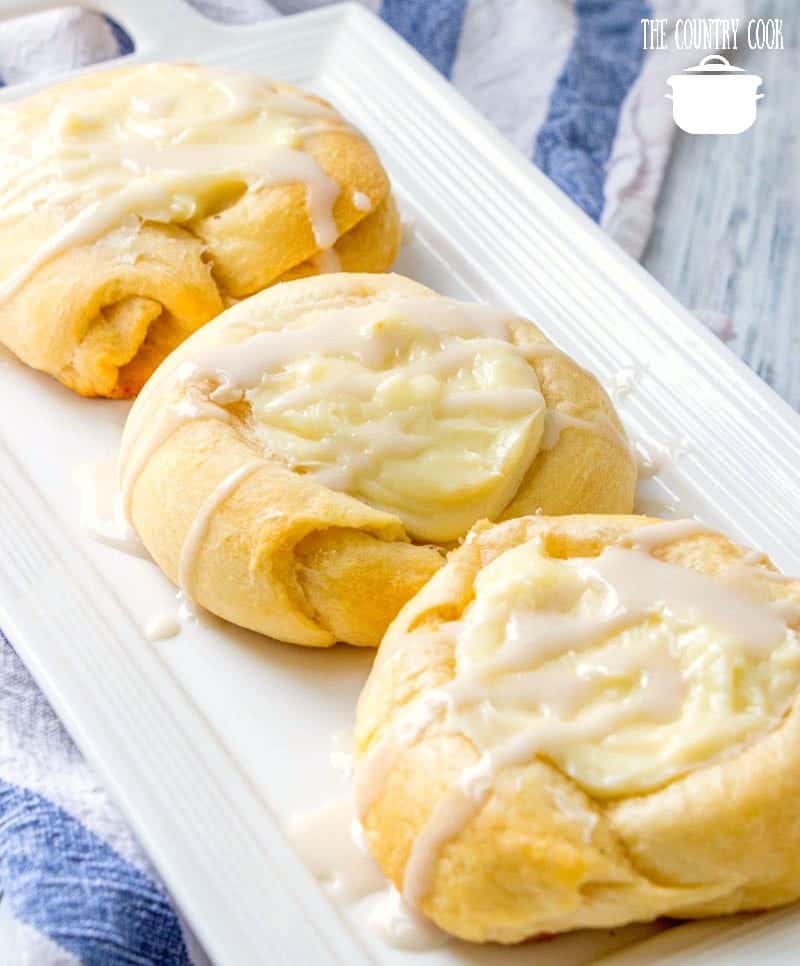 Easy Cheese Danishes made with crescent rolls and layered on a white platter.