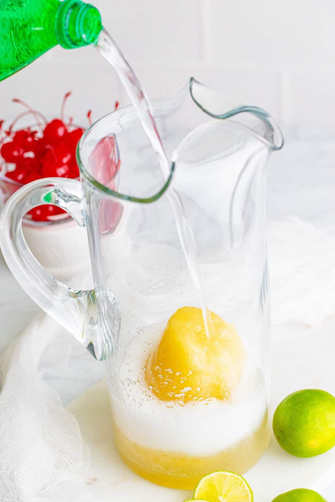 pouring Sprite in a pitcher with frozen limeade concentrate. 