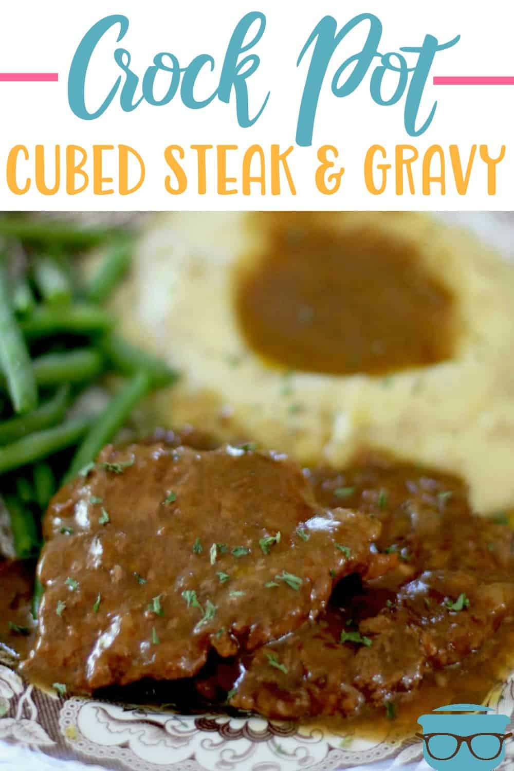 Crock Pot Cubed Steak and Gravy served on a plate with green beans and mashed potatoes. Recipe from The Country Cook.