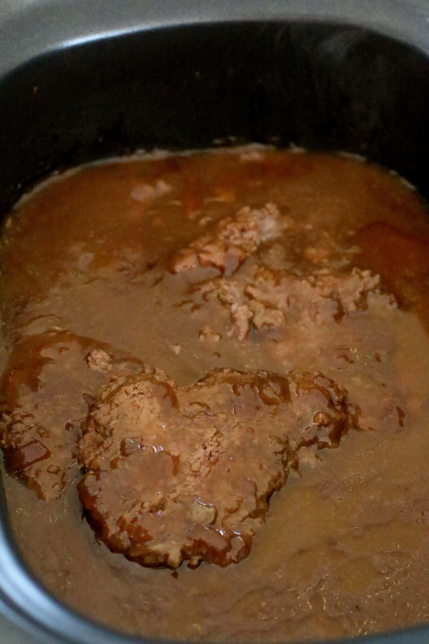 thickened gravy and cooked cubed steak in a slow cooker.