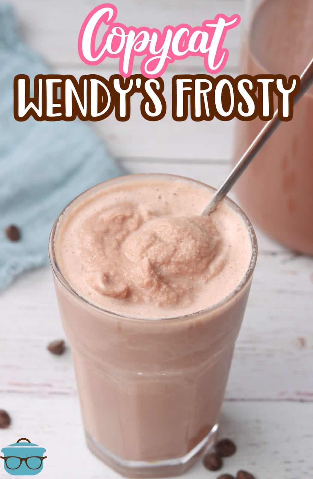 overhead photo of Wendy's Frosty in a clear glass with a spoon stuck inside. 