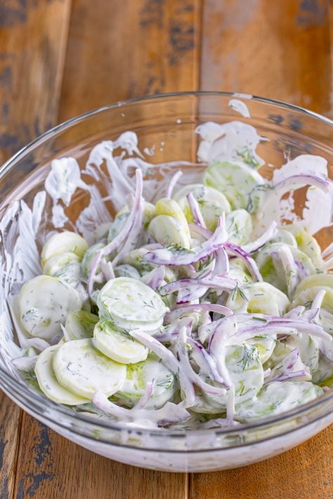 Dressing covered Cucumber Salad in a bowl.