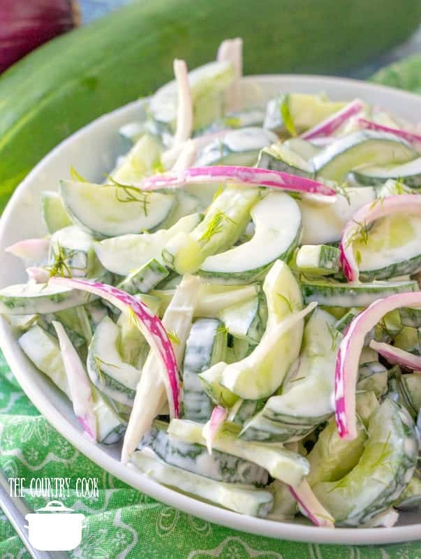 Creamy Cucumber Dill Salad in a white serving bowl.