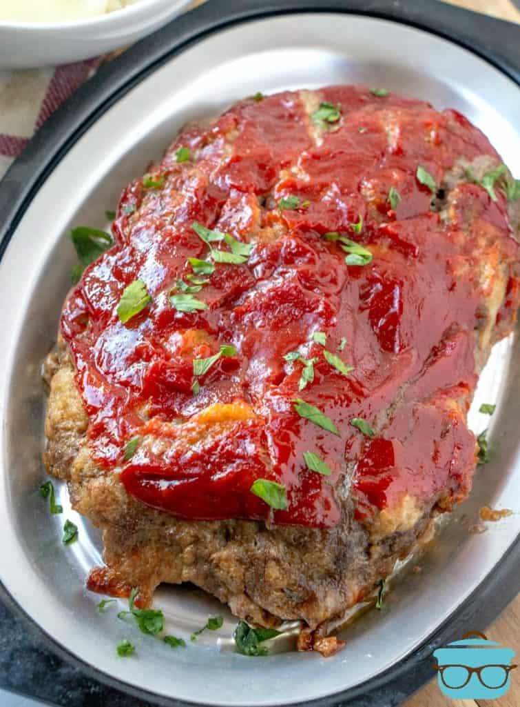 The best meatloaf on a platter, garnished with parsley flakes