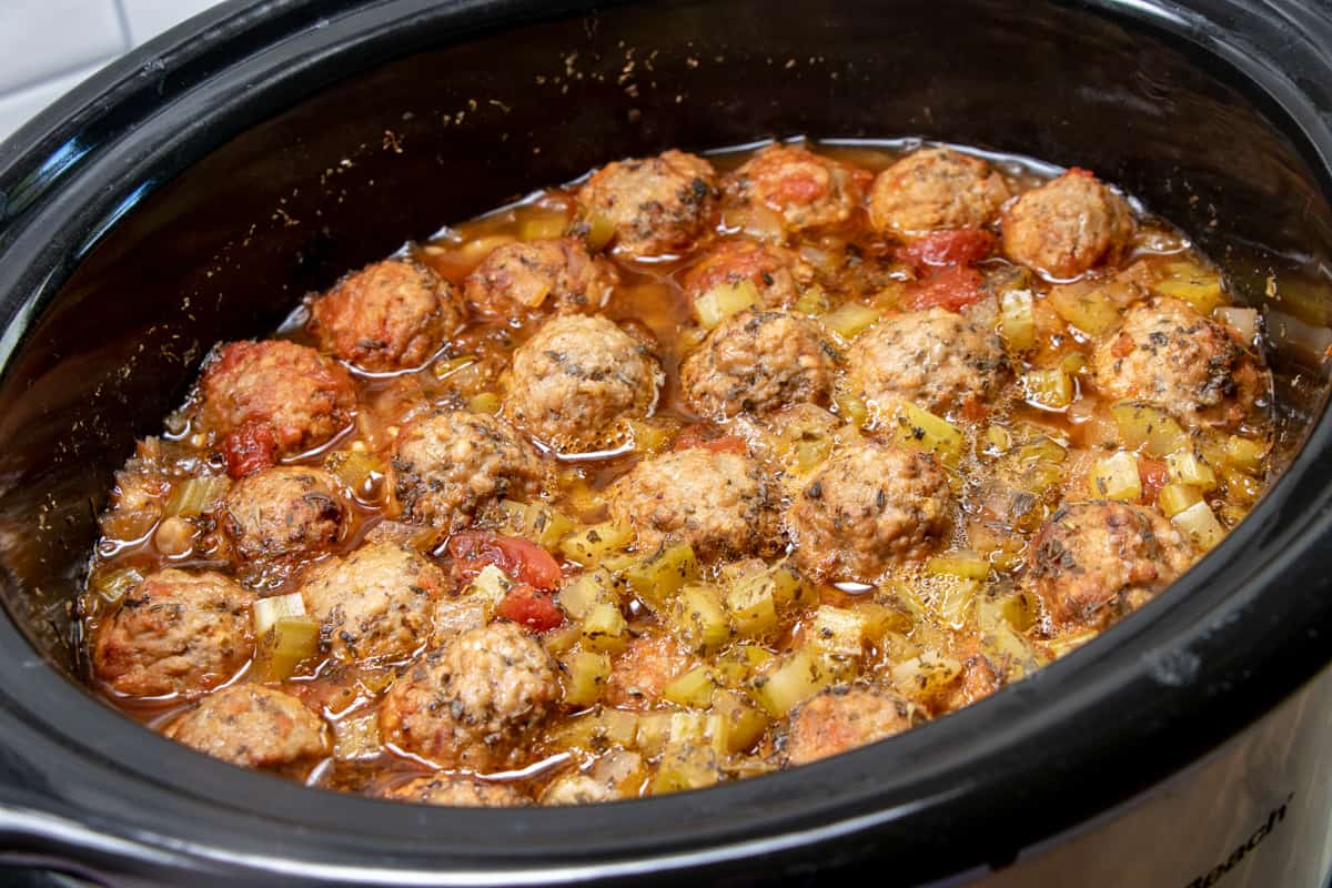 fully cooked meatballs and seasoned beef broth in a slow cooker (after 3 hours of cooking).