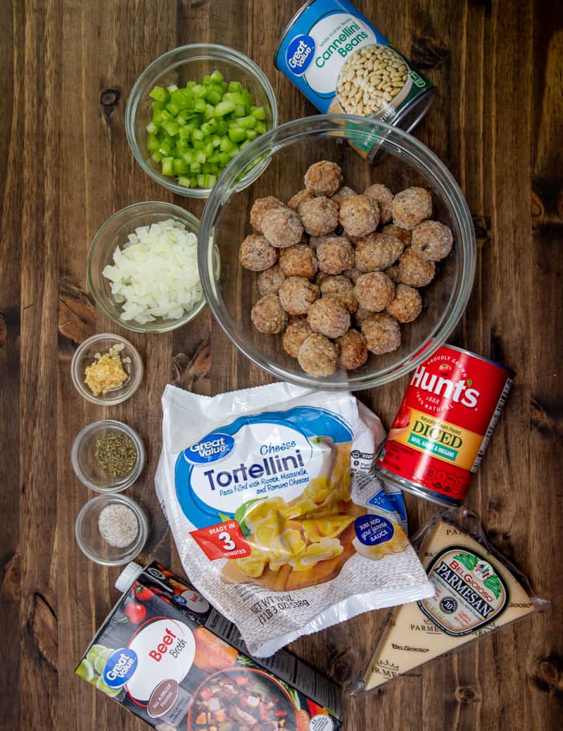 frozen Italian meatballs, frozen cheese tortellini, container beef broth, cannellini beans, Italian diced tomatoes (with basil, garlic and oregano), yellow onion, garlic, celery, Italian seasoning, salt and pepper, grated parmesan cheese.