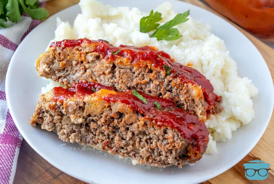 slices, meatloaf on a plate with mashed potatoes.