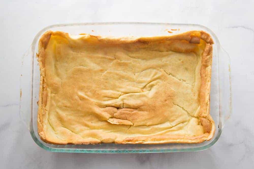 cream puff pastry layer fully baked in a clear baking dish.