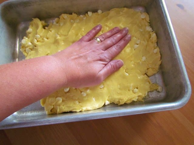 spreading cake mix blondie mixture into baking pan