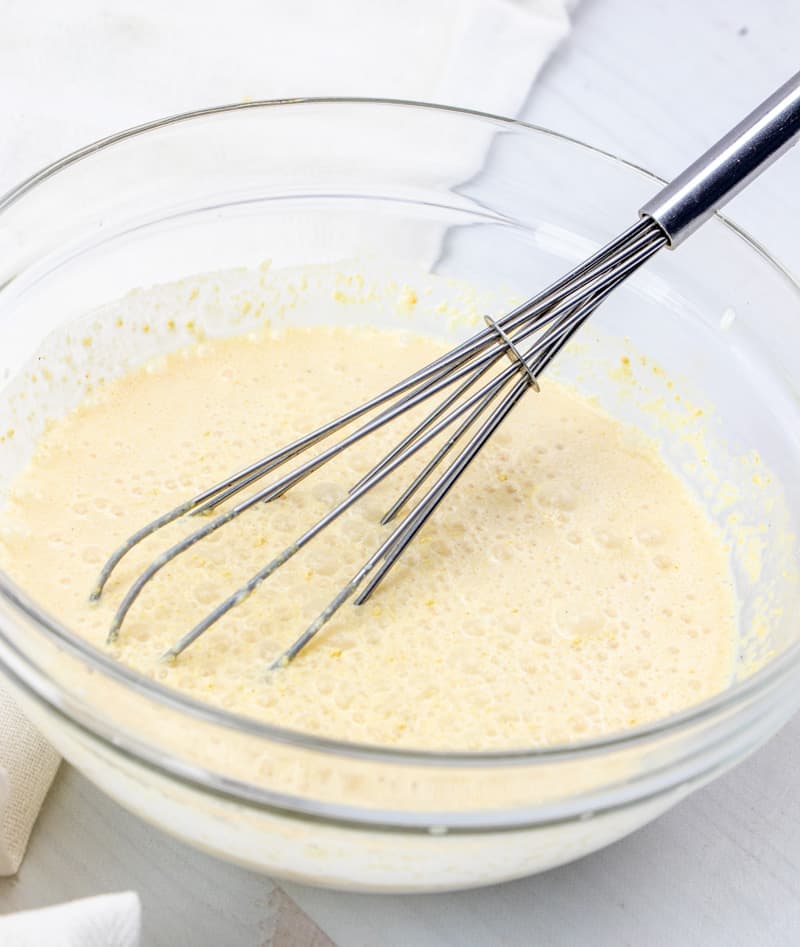 chicken gravy mix with milk whisked together in a bowl.
