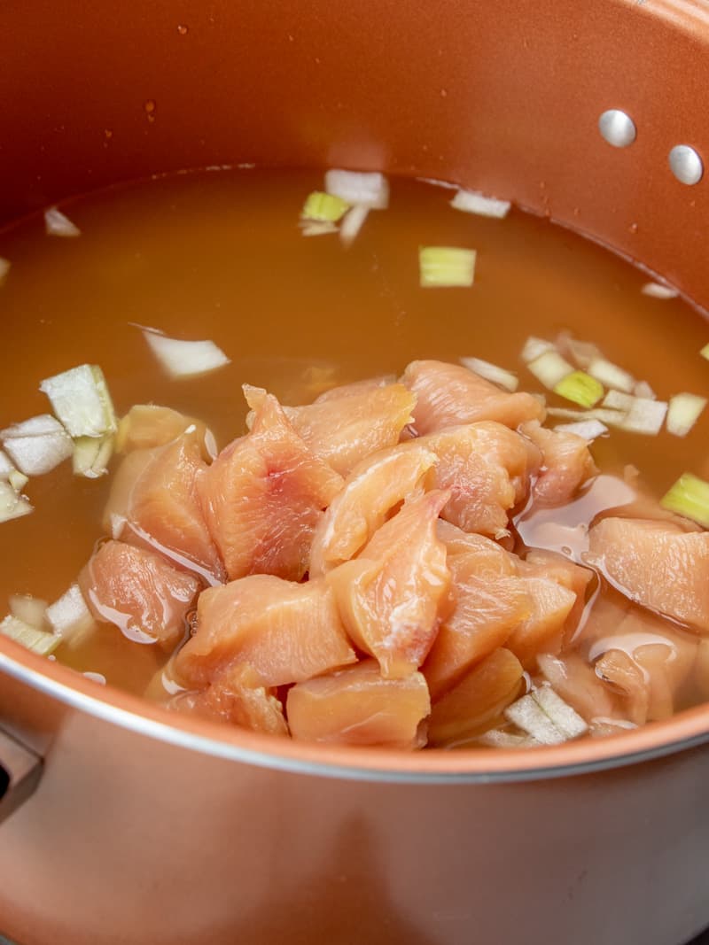 chicken broth, diced onions and diced chicken tenders in a large pot.