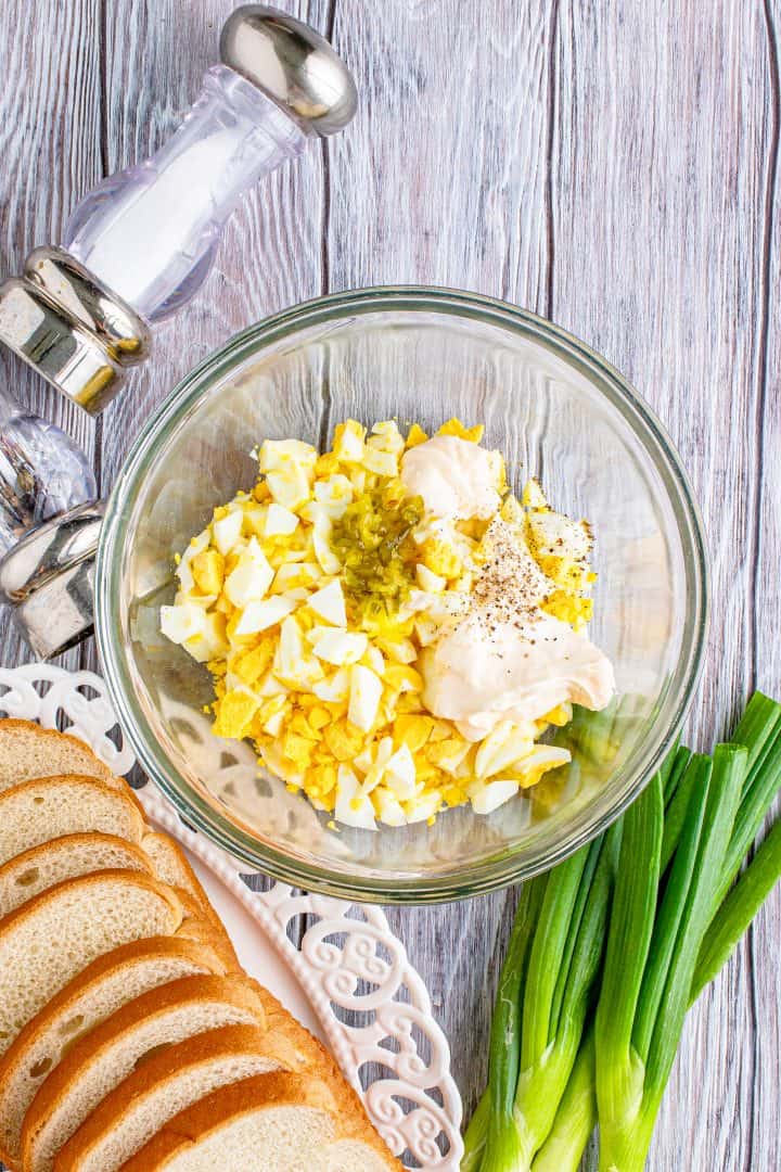 chopped hard cooked eggs, sweet relish, salt, pepper and mayonnaise added together in a bowl