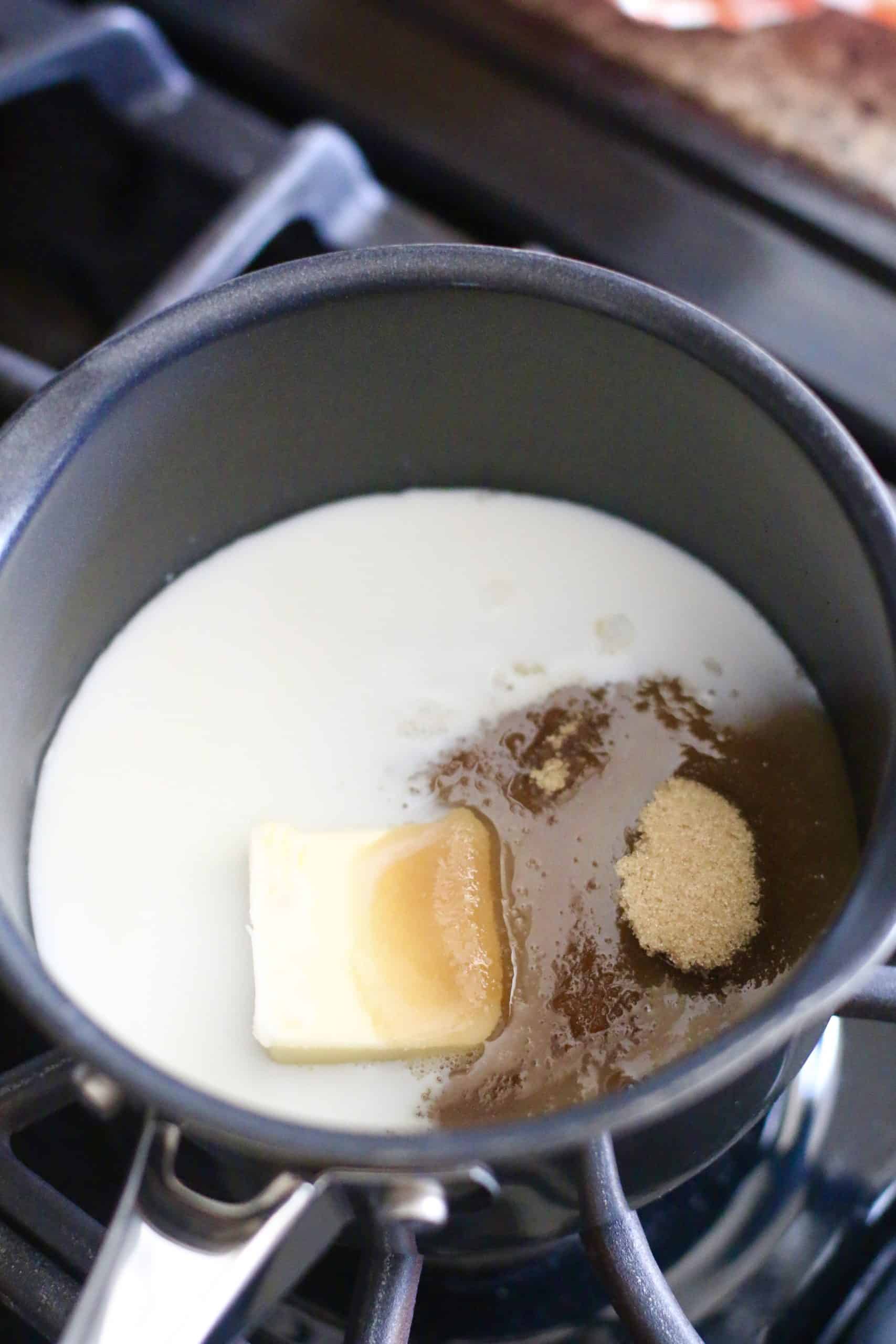 butter, brown sugar and milk added to a saucepan on the stove. 