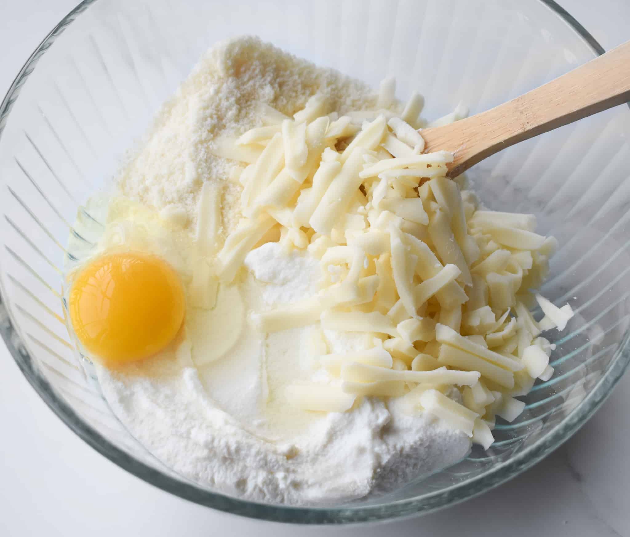 ricotta cheese, egg, mozzarella cheese in a bowl.