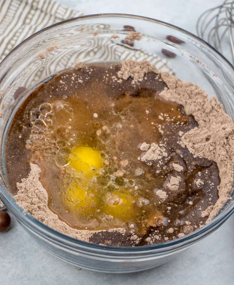 chocolate cake mix, malted milk powder, eggs, oil and water combined in a bowl.