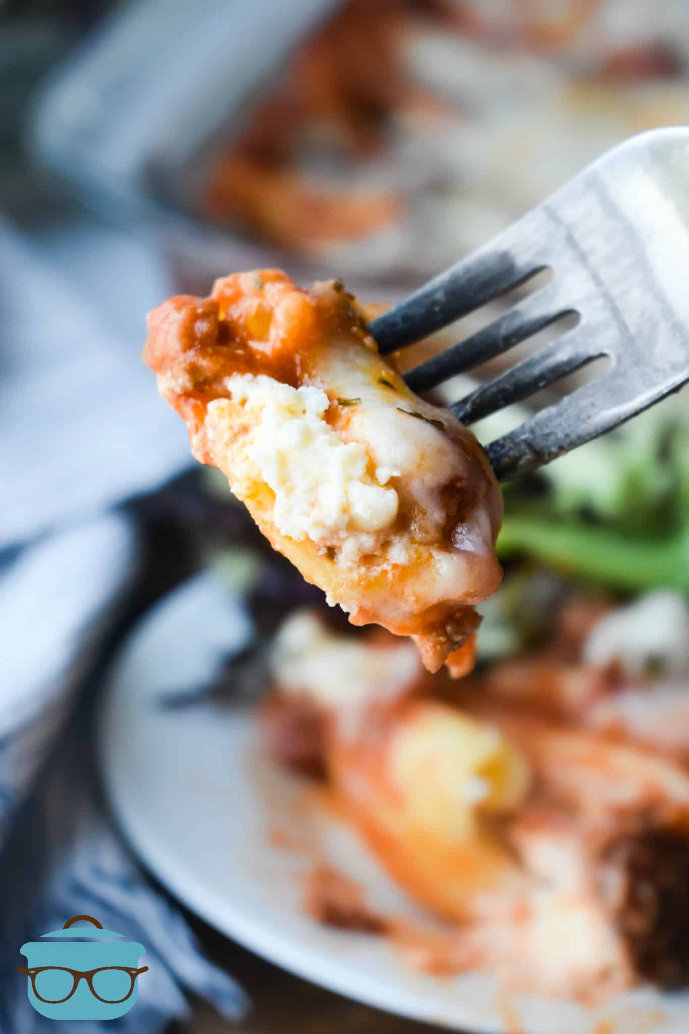 a fork holding up a bite of stuffed shells.