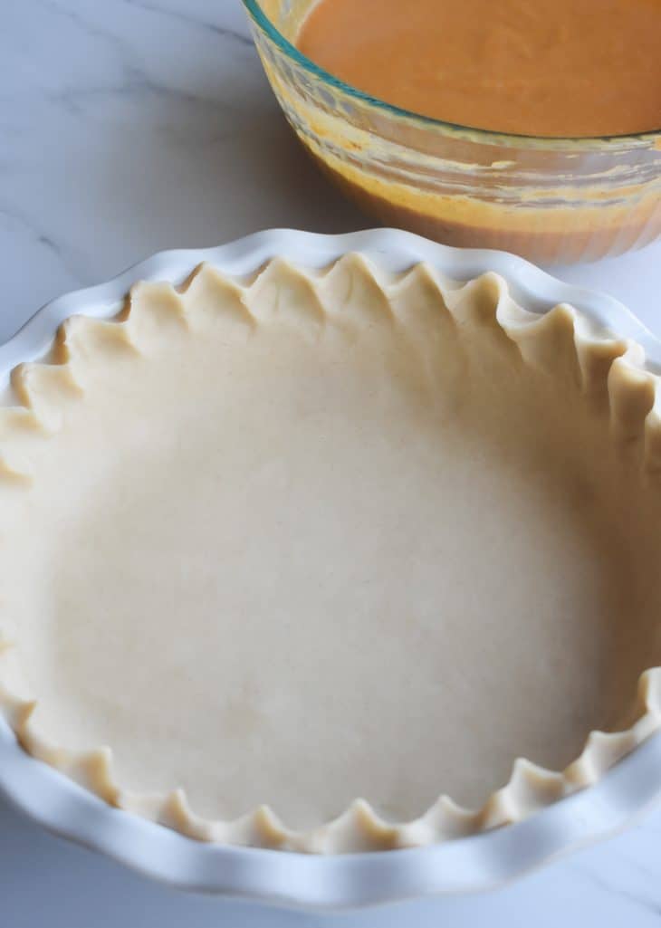refrigerated pie crust pressed into the bottom of a pie pan and the edges crimped.