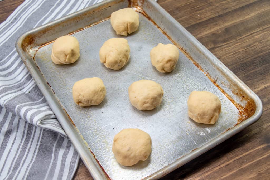 crescent roll popper bites on a greased baking sheet