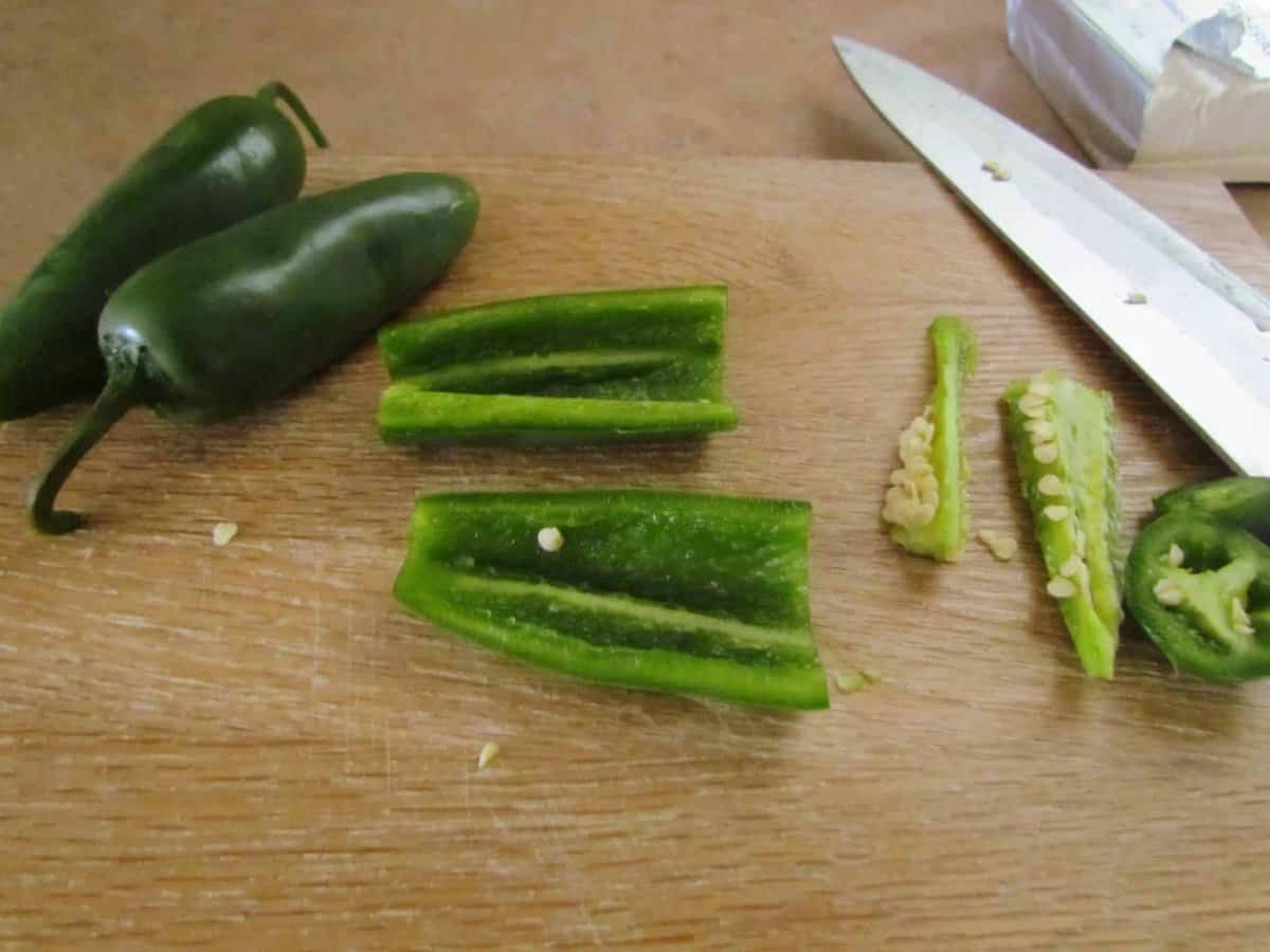 slicing and dicing jalapeños on a cutting board.