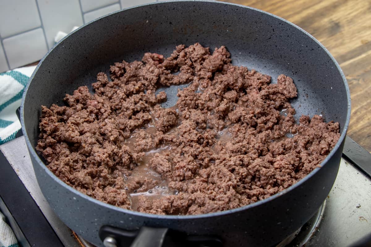 cooked and crumbled ground beef in a sauce pan.