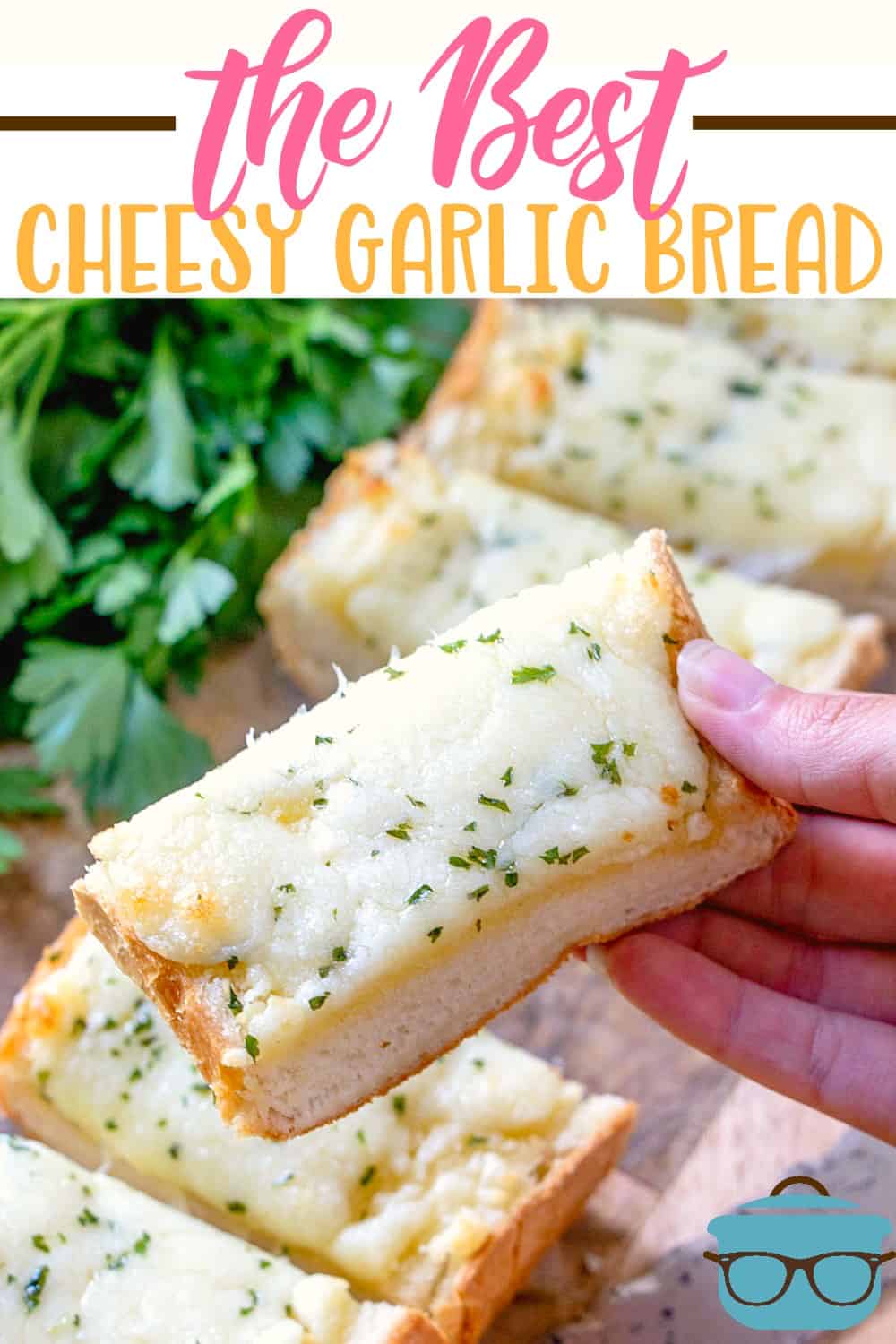 hand holding up a slice of cheese garlic bread.