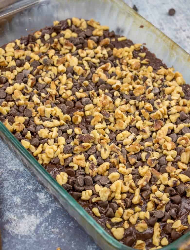 semi-sweet chocolate chips and chopped walnuts on brownie cake batter