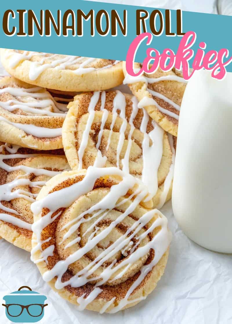 Easy Cinnamon Roll Cookies recipe from The Country Cook. Cookies shown stacked on white parchment paper with a bottle of milk on the side.