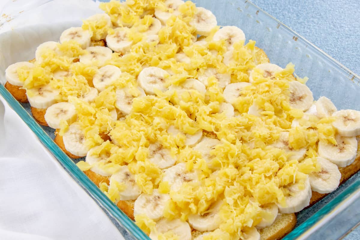 crushed pineapple spread on top of sliced bananas.