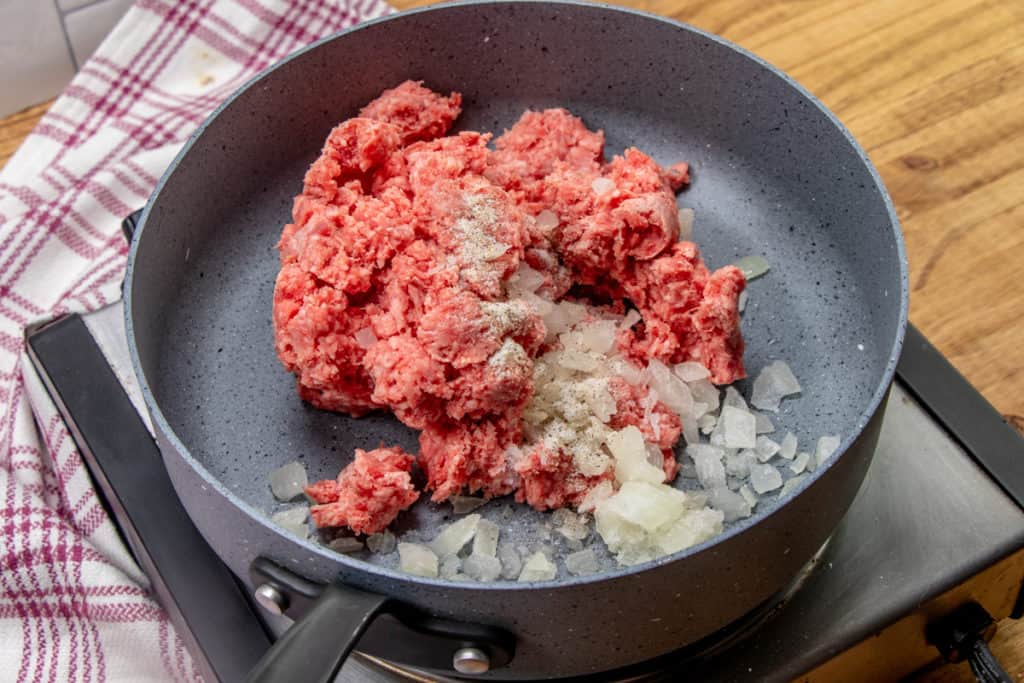 browning ground beef and chopped onion in a large skillet.