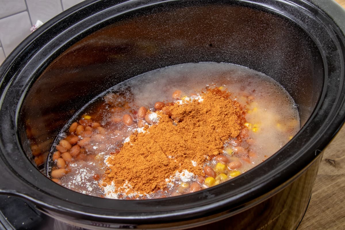 cooked ground beef, onions, diced tomatoes, corn, pinto beans and beef broth poured into 6-quart slow cooker