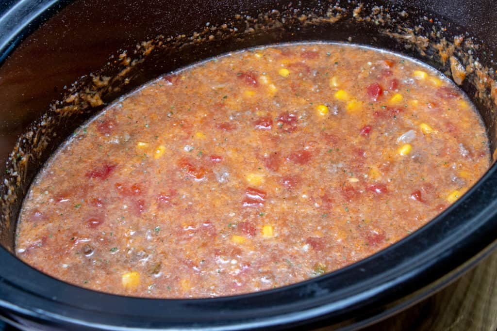 stirred crock pot soup mixture in oval 6-quart crock pot.